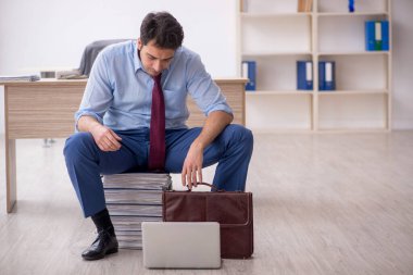 Young employee unhappy with excessive work at workplace