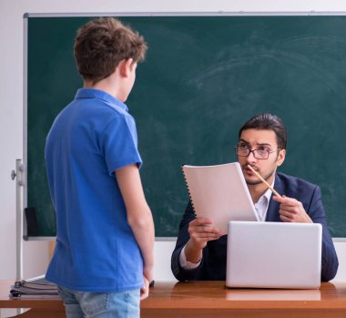 Erkek öğretmen ve okul çocuğu sınıfta.