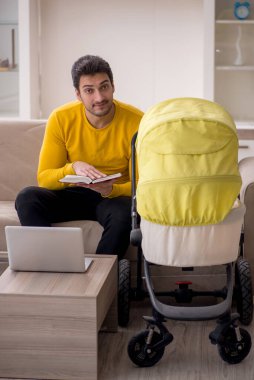Young contractor looking after baby at home