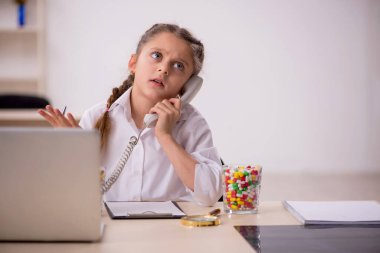 Little girl playing doctor in telemedicine concept