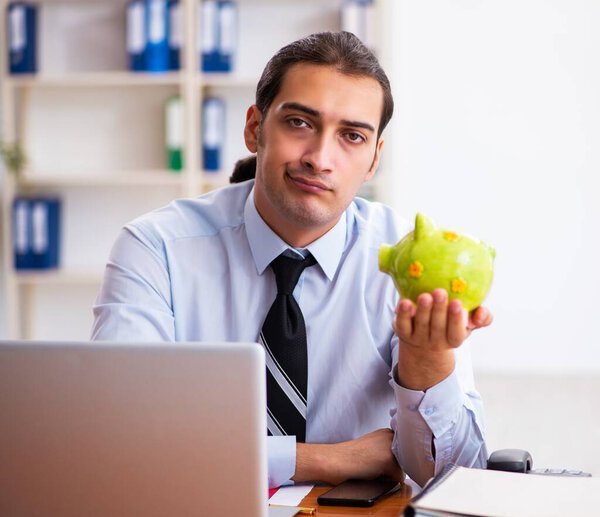 Young employee in payment concept at workplace