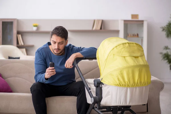 Man looking after new born at home