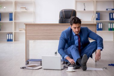 Young employee unhappy with excessive work at workplace
