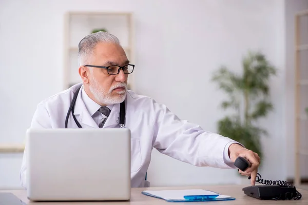 Old doctor in telemedicine concept