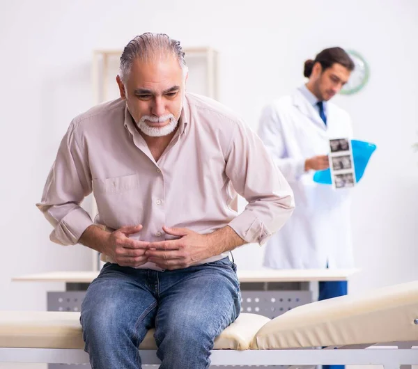 Old Patient Visiting Young Doctor — Stock Photo, Image