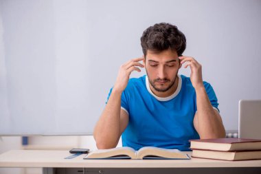 Genç öğrenci beyaz tahtanın önünde.