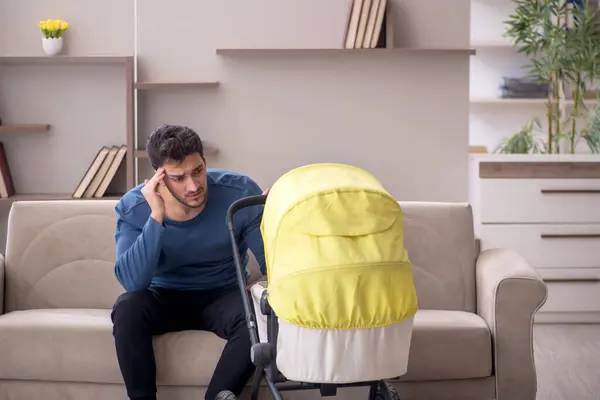 Young contractor looking after baby at home
