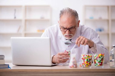 Old doctor suggesting pills at the hospital