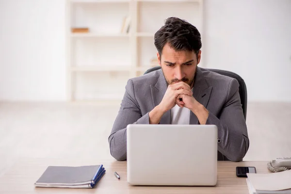 stock image Young employee sitting at workplace