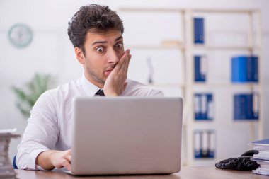 Young employee and too much work at workplace