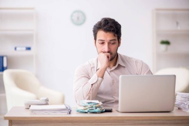 Young accountant sitting at workplace