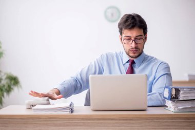 Ofiste telefonla konuşan genç bir çalışan.