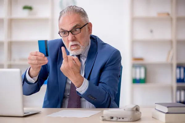 Old employee holding credit card