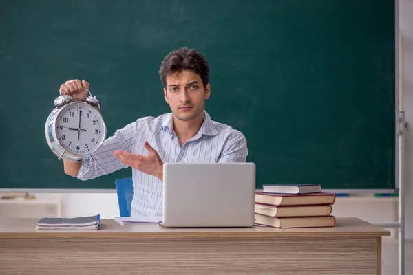 Young teacher in time management concept