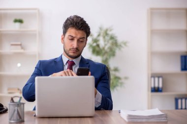 Genç çalışan işyerinde oturuyor.