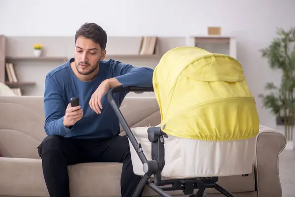 Man looking after new born at home