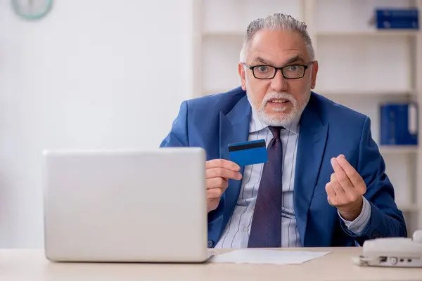 Old employee holding credit card