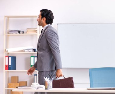 The young handsome businessman employee in the office