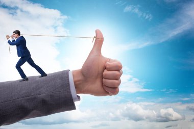 İş adamı onay konseptinde ip çekiyor.