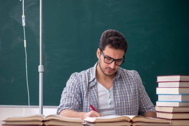 Young teacher suffering in the classroom