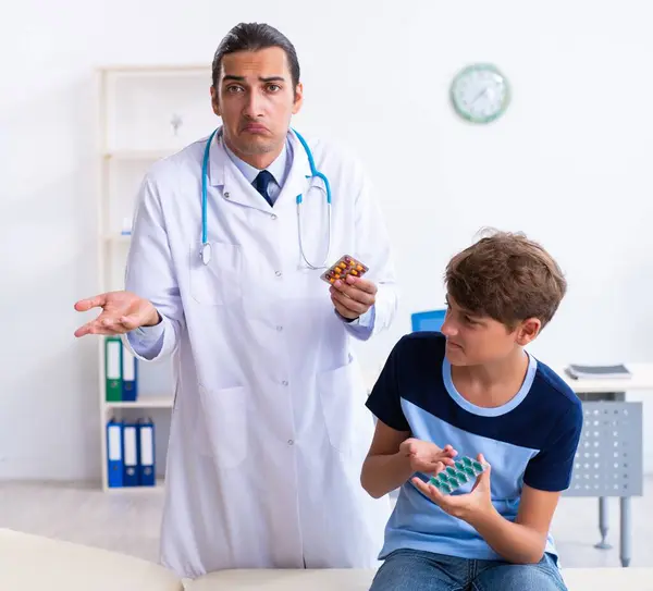 Den Unga Manliga Läkaren Undersöker Pojken Kliniken — Stockfoto
