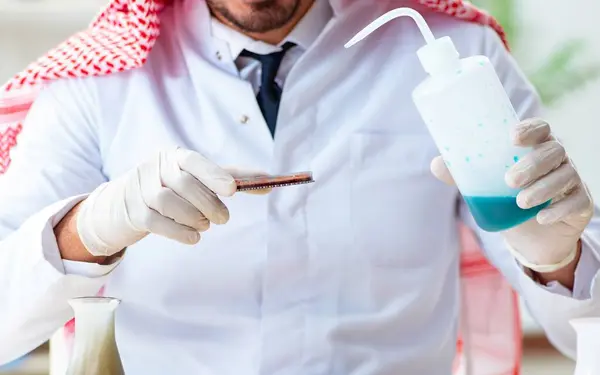 The arab chemist working in the lab office