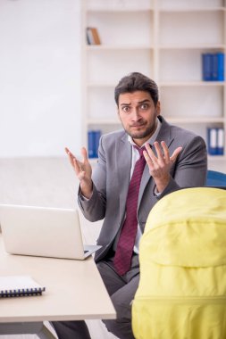 Young employee looking after newborn in the office