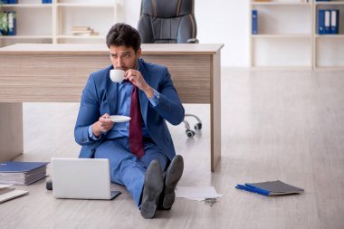 Young employee unhappy with excessive work at workplace