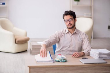 Young accountant sitting at workplace