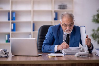 Ofiste çalışan eski bir işadamı.