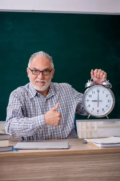 Old teacher in time management concept