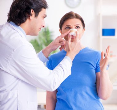 The woman visiting male doctor for plastic surgery