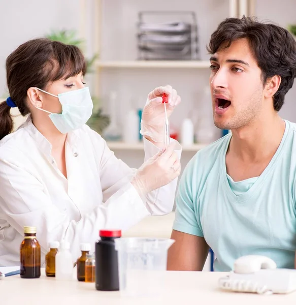 The doctor getting saliva test sample in clinic hospital