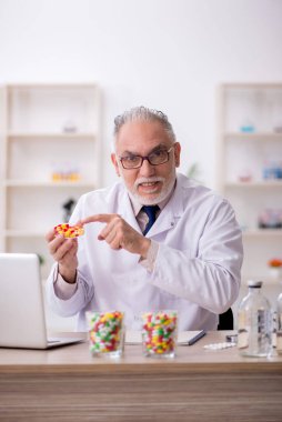 Old doctor suggesting pills at the hospital