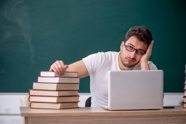 Sınıfta oturan genç öğrenci.