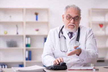 Teletıp konseptinde yaşlı bir doktor.