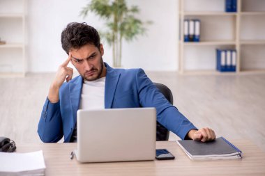 Genç çalışan işyerinde oturuyor.