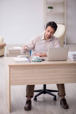 Young accountant sitting at workplace