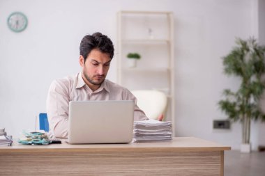 Young accountant sitting at workplace