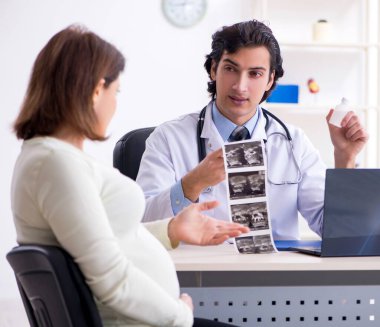 The old pregnant woman visiting young male doctor