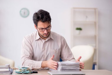 Young accountant sitting at workplace