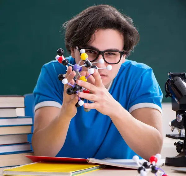 Sınıftaki genç erkek öğrenci.