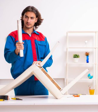 Mobilya montajında çalışan genç marangoz.