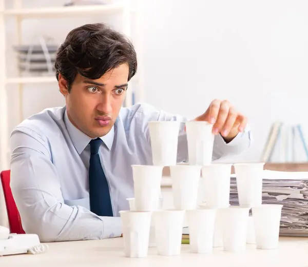 Young Employee Building Pyramid Plastic Cups — Stock Photo, Image