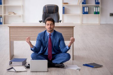 Young employee unhappy with excessive work at workplace