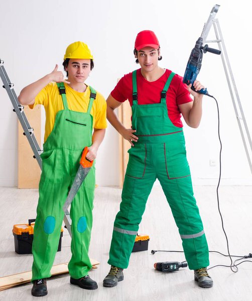 The two workers contractors working indoors