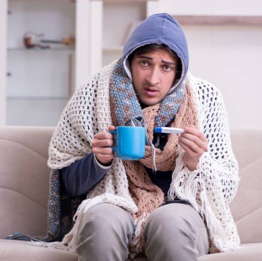 Evde acı çeken genç adam.