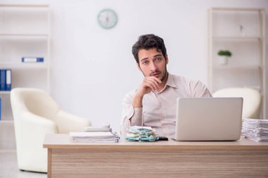 Young accountant sitting at workplace