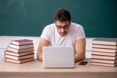 Sınıfta oturan genç öğrenci.