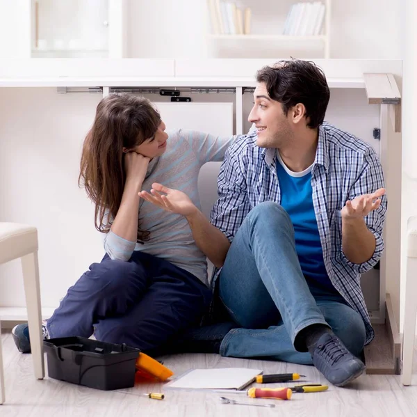 The man and woman assembling furniture at home